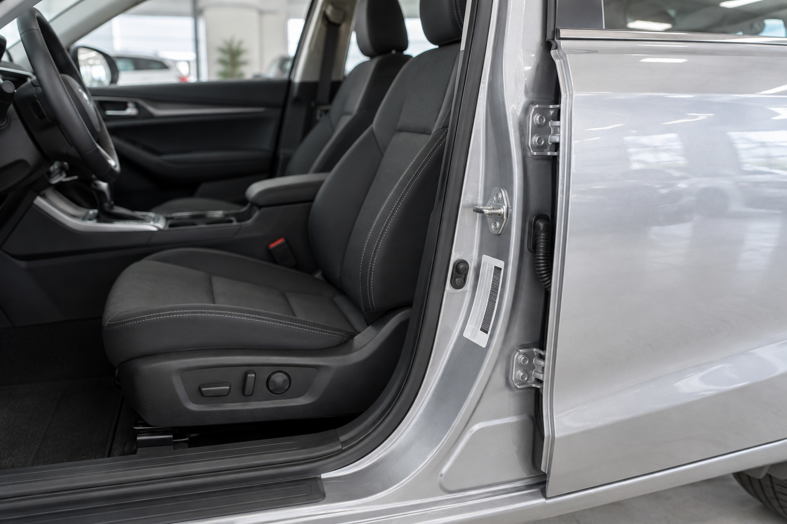 Open driver's door showing the vehicle information label on the door jamb